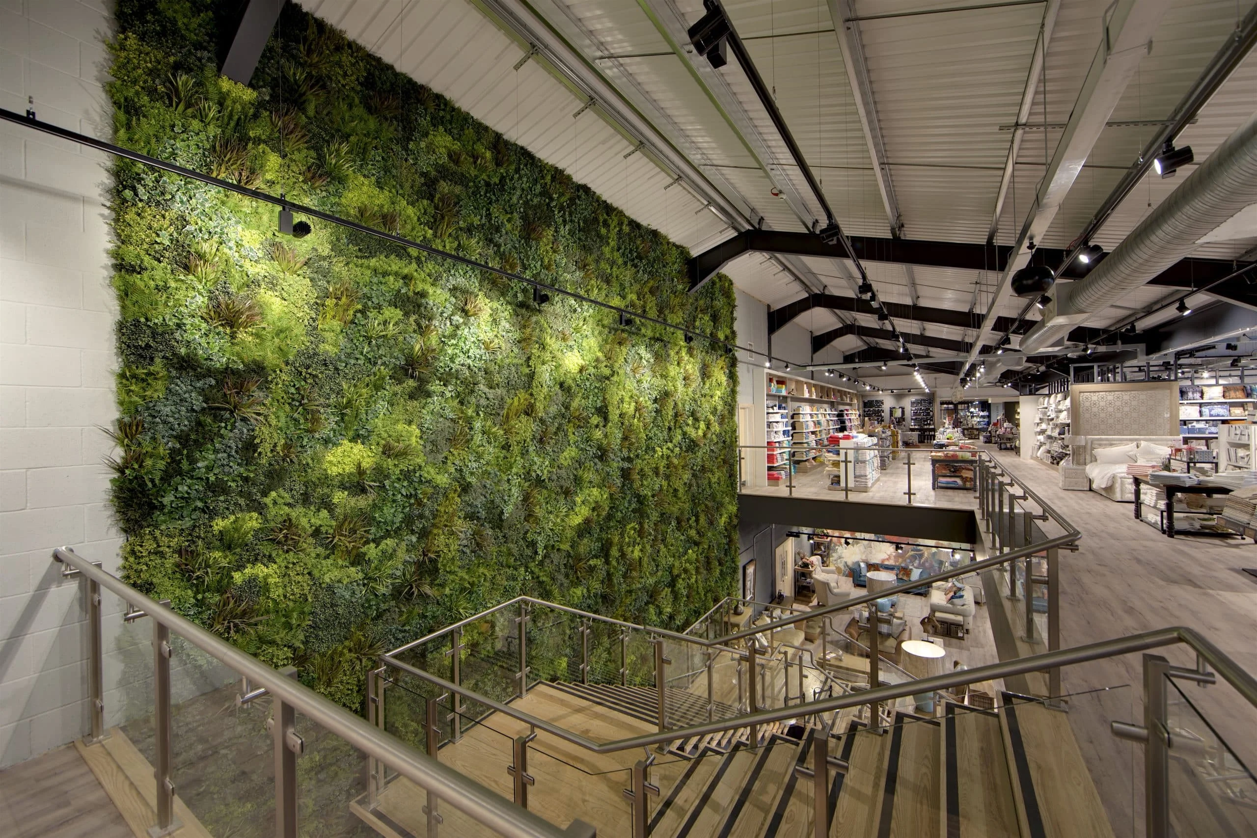 Lush Artificial Vertical Garden Installation by staircase of Furniture Store