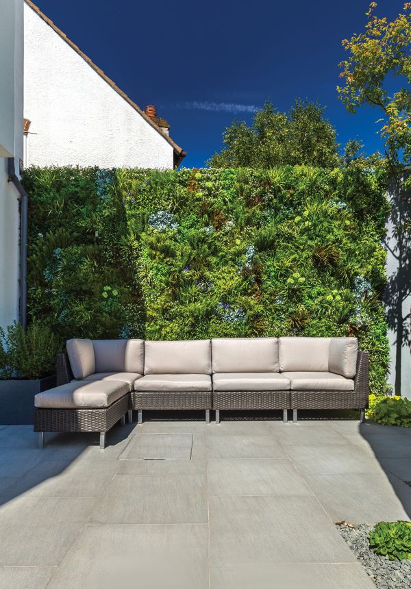 Backyard with sound buffering artificial vertical garden to create privacy and acoustic buffering solution 