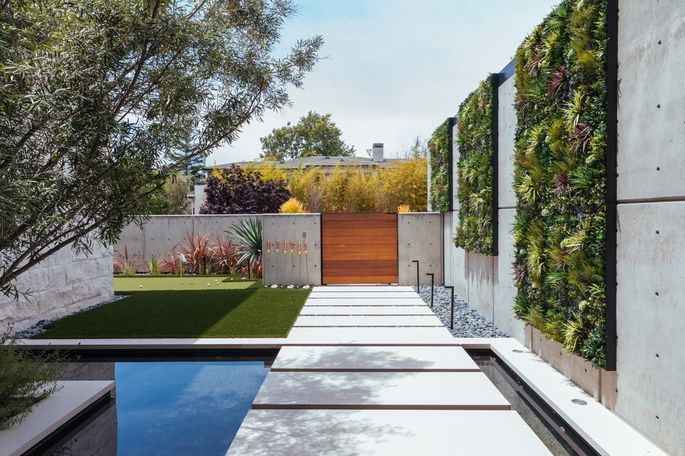 Modern Outdoor Garden with Artificial Green Wall by pool